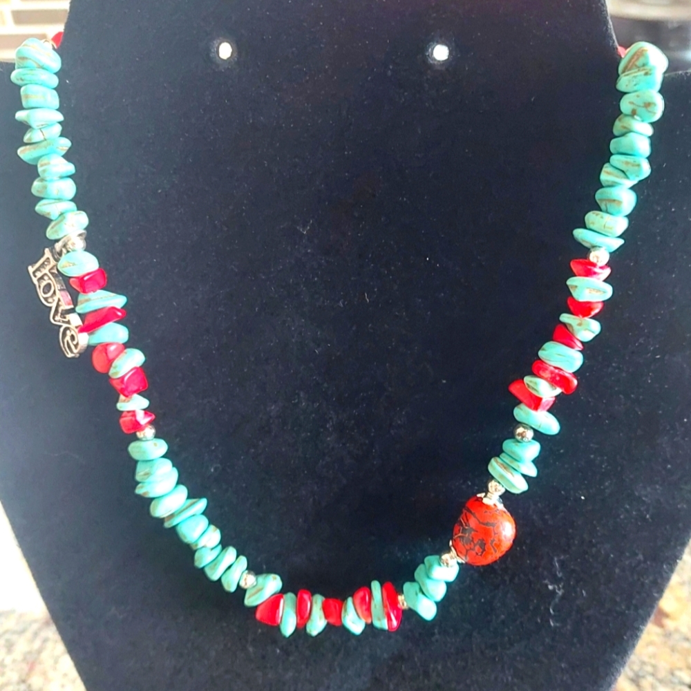 Turquoise howlite necklace with a red tagua nut and coral nuggets 16 inches
